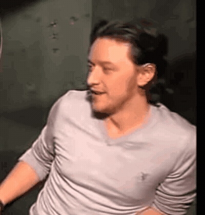 Man In White Shirt Standing In Dark Room GIF