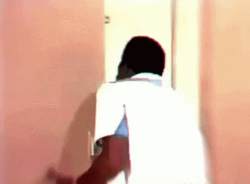 Man In White Shirt Standing In Doorway GIF