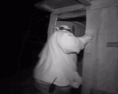 Man In White Shirt Standing In Doorway With Walkie Talkie GIF