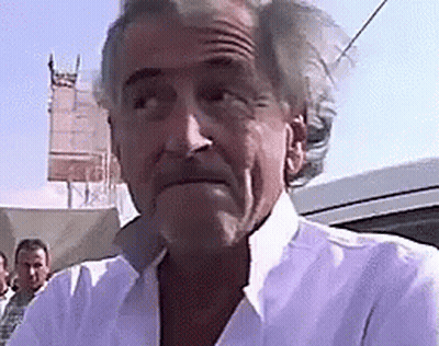 Man In White Shirt Standing In Front Of Car GIF