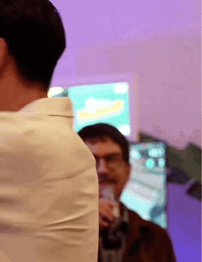 Man In White Shirt Standing In Front Of Coca Cola Screen GIF