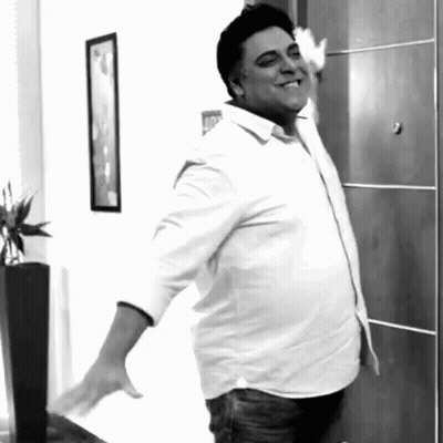 Man In White Shirt Standing In Front Of Door GIF