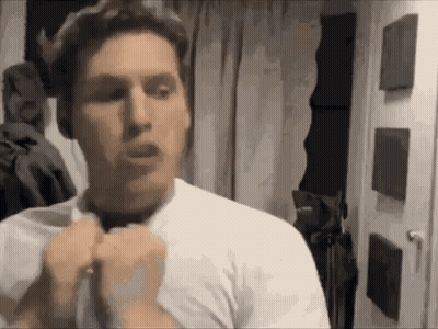 Man In White Shirt Standing In Front Of Door GIF