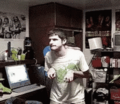 Man In White Shirt Standing In Front Of Laptop GIF