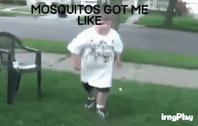 Man In White Shirt Standing In Grass Saying Mosquitos Got Me Like GIF