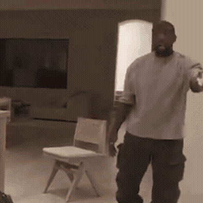 Man In White Shirt Standing Next To Child Chair GIF