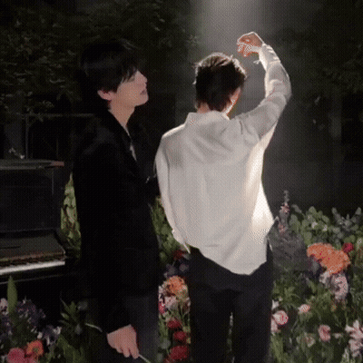 Man In White Shirt Standing Next To Man In Black Suit GIF