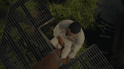 Man In White Shirt Standing On Metal Grid GIF