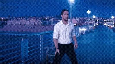 Man In White Shirt Standing On Pier At Night GIF
