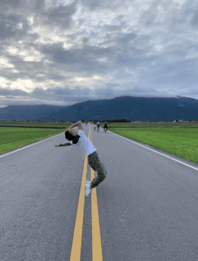 Man In White Shirt Standing On Road GIF