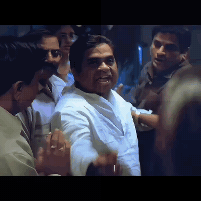 Man In White Shirt Surrounded By Men GIF