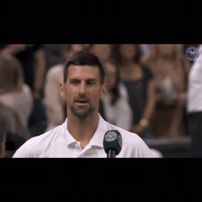 Man In White Shirt Talking Into Microphone With Wimbledon Logo GIF