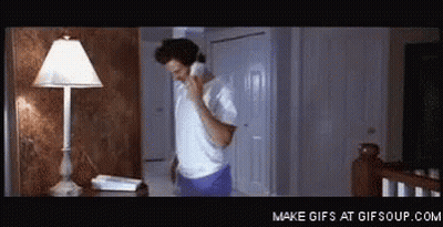 Man In White Shirt Talking On Phone GIF