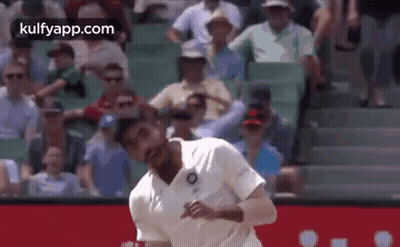 Man In White Shirt Throwing Ball In Front Of Crowd GIF