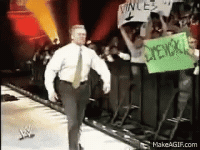 Man In White Shirt Walking On Stage With Vince Sign GIF