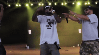 Man In White Shirt With Bear Singing Into Microphone GIF