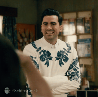 Man In White Shirt With Blue Flowers Smiling GIF