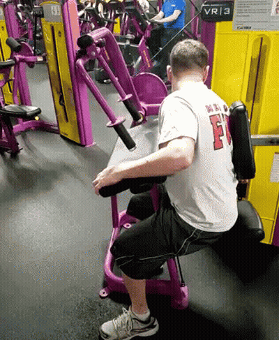 Man In White Shirt With F On Gym Machine GIF