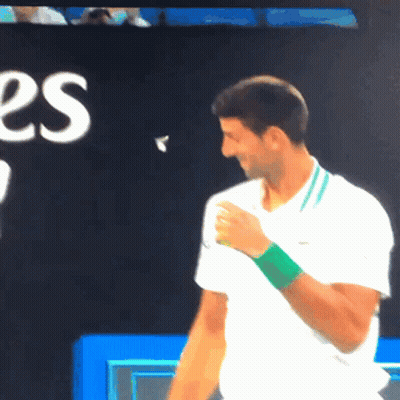 Man In White Shirt With Green Wristband Smiling GIF