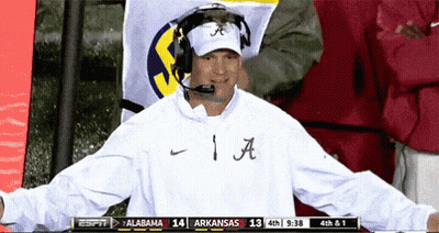 Man In White Shirt With Letter A Standing Before Flag GIF