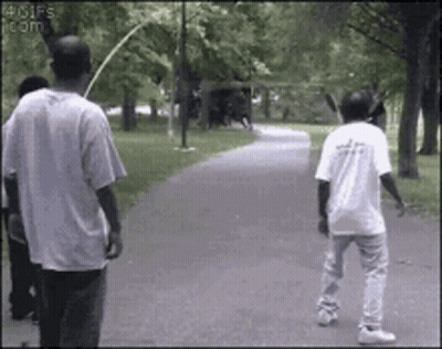 Man In White Shirt With Letter A Walking Down Path GIF