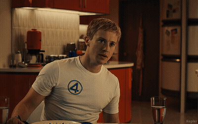 Man In White Shirt With Number 4 Sitting At Table GIF