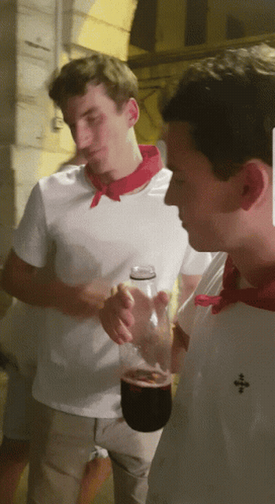 Man In White Shirt With Red Scarf Holding Wine GIF