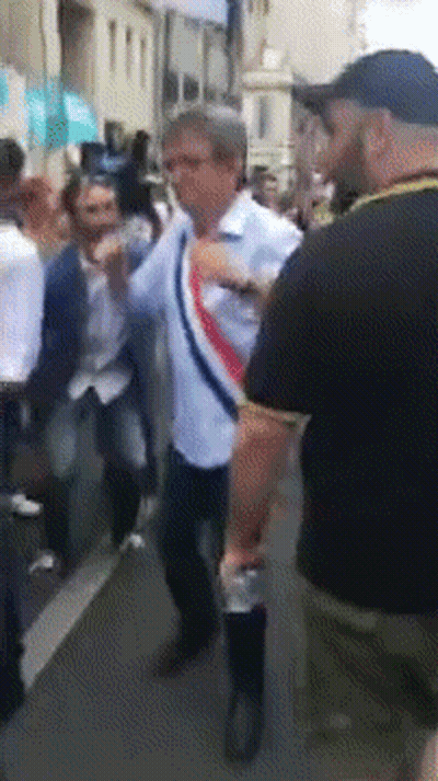 Man in White Shirt With Red White Blue Scarf in Crowd