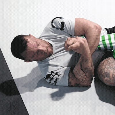 Man In White Shirt With Skull Lying Down GIF