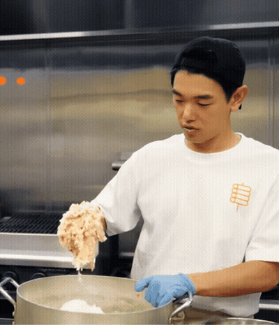Man In White Shirt With Stick Cooking GIF