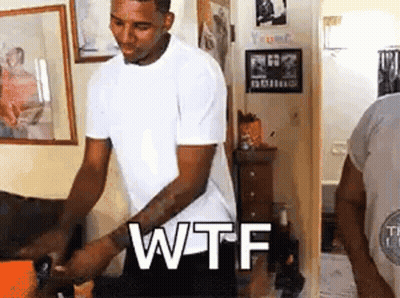 Man In White Shirt With WTF On Wall GIF