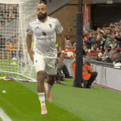 Man In White Snapdragon Shirt Running Soccer Field GIF