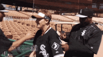 Man In White Sox Shirt Being Helped GIF