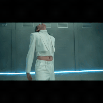 Man In White Suit Beside Wall With Letter CC GIF