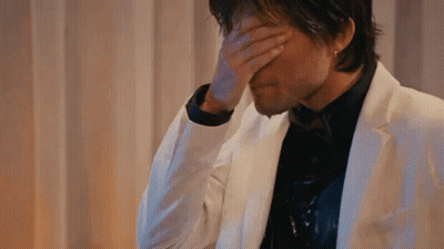 Man In White Suit Covering Face GIF