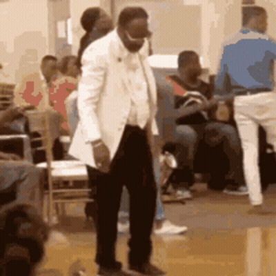 Man In White Suit Dancing In Front Of Crowd GIF