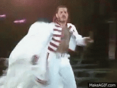 Man In White Suit Dancing On Stage GIF