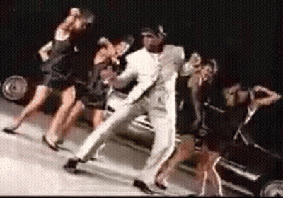 Man In White Suit Dancing With Women GIF