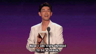 Man In White Suit Holding Trophy Says Now I Am Truly Thrilled To Be A Snack GIF