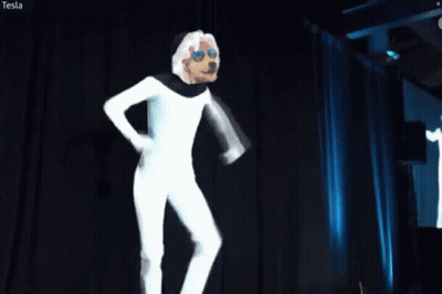 Man In White Suit In Front Of Tesla Screen GIF