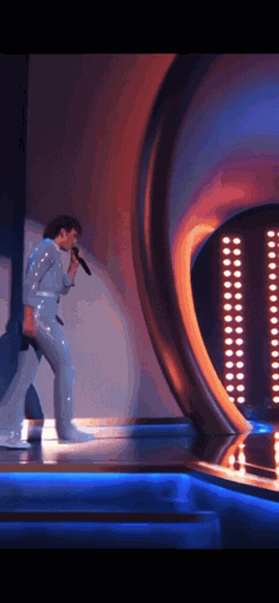 Man In White Suit Singing Into Microphone GIF