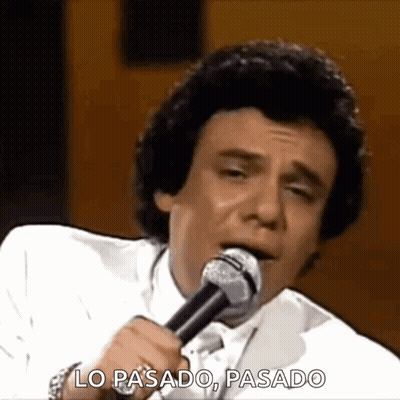 Man In White Suit Singing Lo Pasado, Pasado GIF