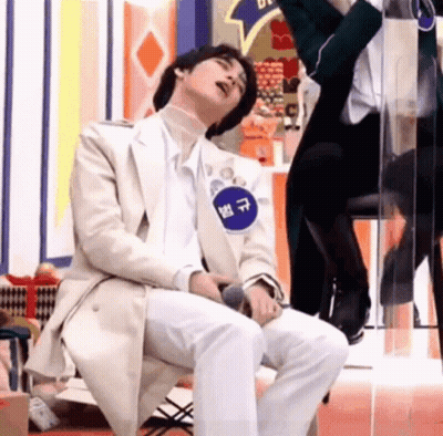 Man In White Suit Sitting With Mouth Open GIF