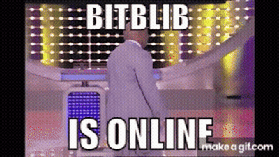 Man In White Suit Standing In Front Of Bit Blib Is Online Screen GIF