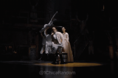 Man In White Suit Standing On Stage With @ 1Chicarandom GIF