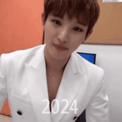 Man In White Suit With 2024 On Chest GIF