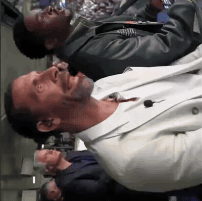 Man In White Suit With Microphone In Mouth GIF