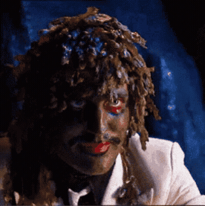 Man In White Suit With Wig And Red Lips GIF