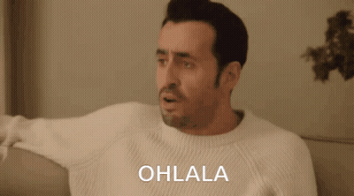 Man In White Sweater On Couch Saying Ohlala GIF
