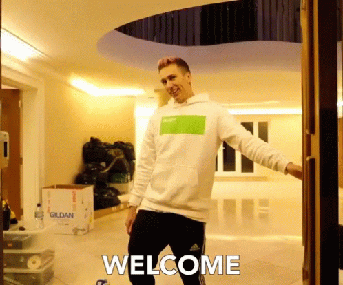 Man In White Sweatshirt And Black Pants In Front Of Gildan Box GIF